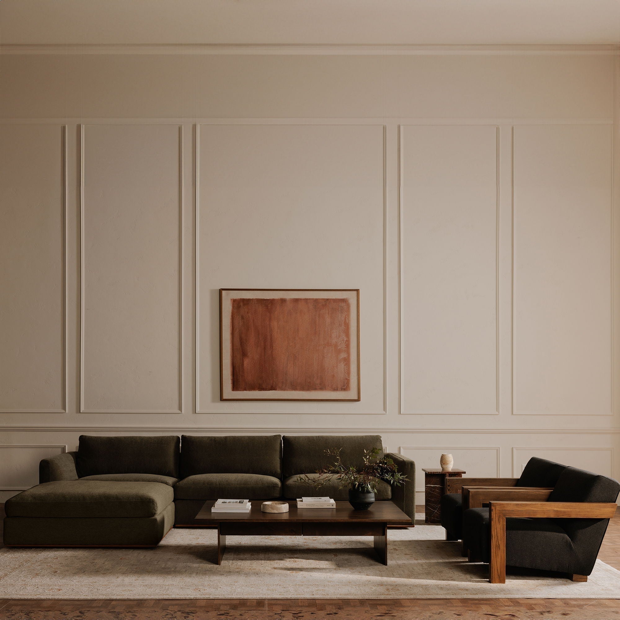 "Garnet" charcoal-coloured lounge chair in a minimalist living room.